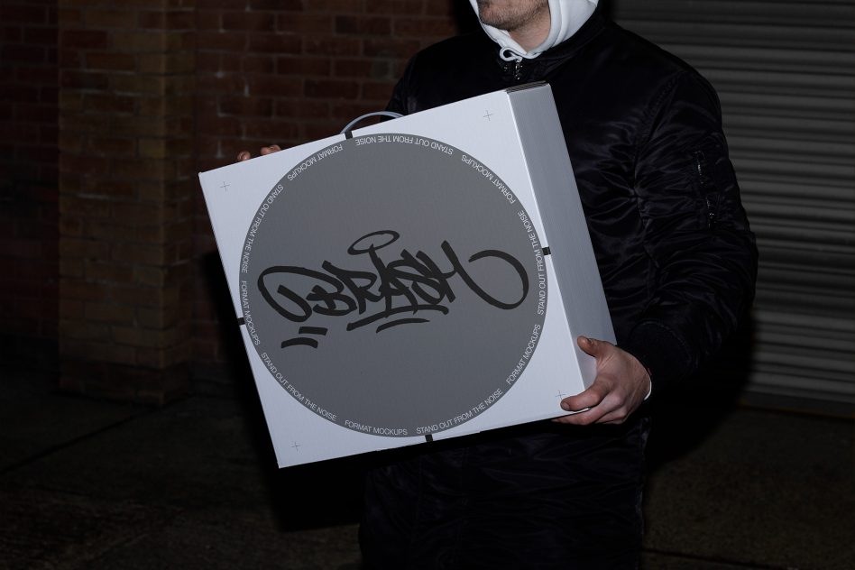 Person holding a large circular graphic design mockup with urban graffiti-style artwork, ideal for presentations and portfolios.